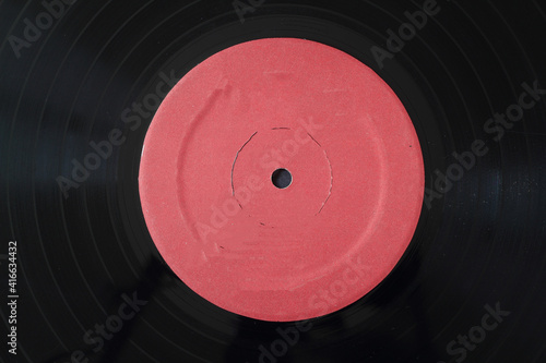 12-inch LP vinyl record disk with blank red label. Close-up shot, top view