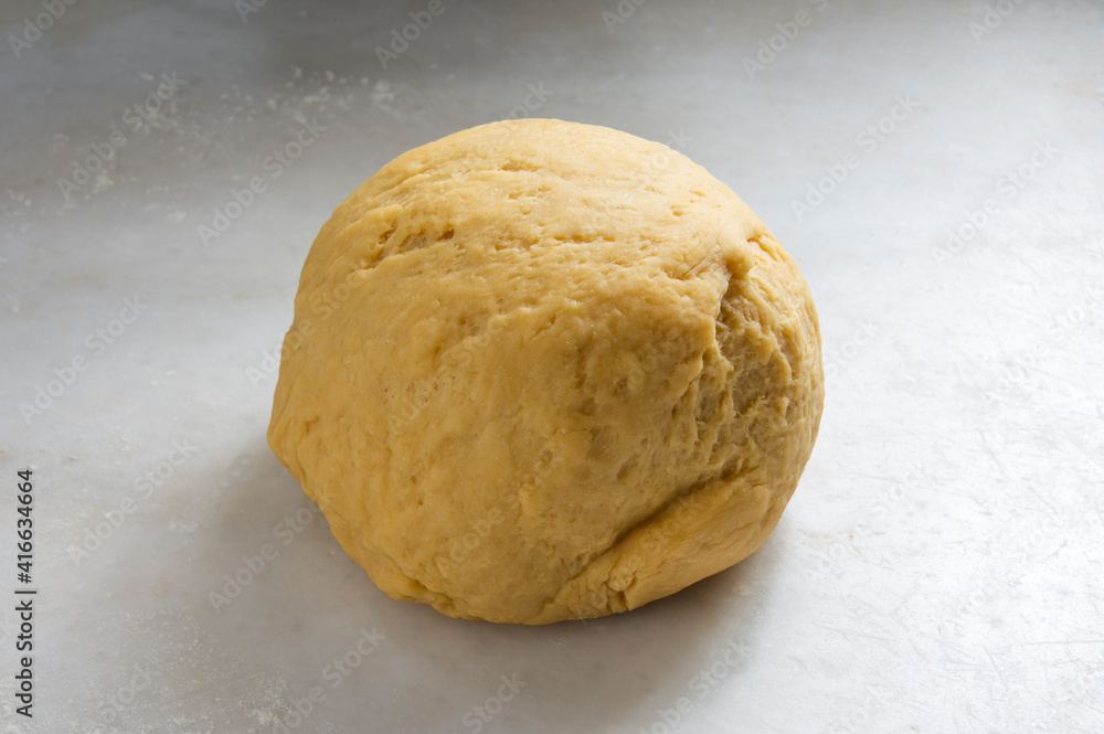 Preparing homemade pasta dough on a white marble background. Preparing homemade pasta dough on a white marble background.