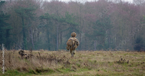 A Royal Gurkha Rifles soldier in full battle gear during an exercise on Salisbury Plain, Wiltshire  photo