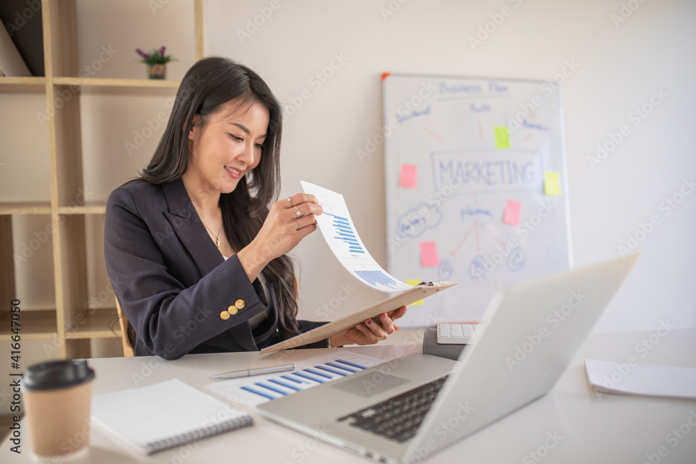Accounting businesswoman working on laptop computer and analyzing real estate investment data, Financial and tax systems concept. Accounting businesswoman working on laptop computer and analyzing real estate investment data, Financial and tax systems concept.