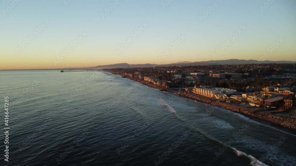 4K Aerial view drone shot of Oceanside Beach coastline in South California with the blue Pacific Ocean with waves coming in and beach with nice houses on the background at the beautiful Sunset 4K Aerial view drone shot of Oceanside Beach coastline in South California with the blue Pacific Ocean with waves coming in and beach with nice houses on the background at the beautiful Sunset