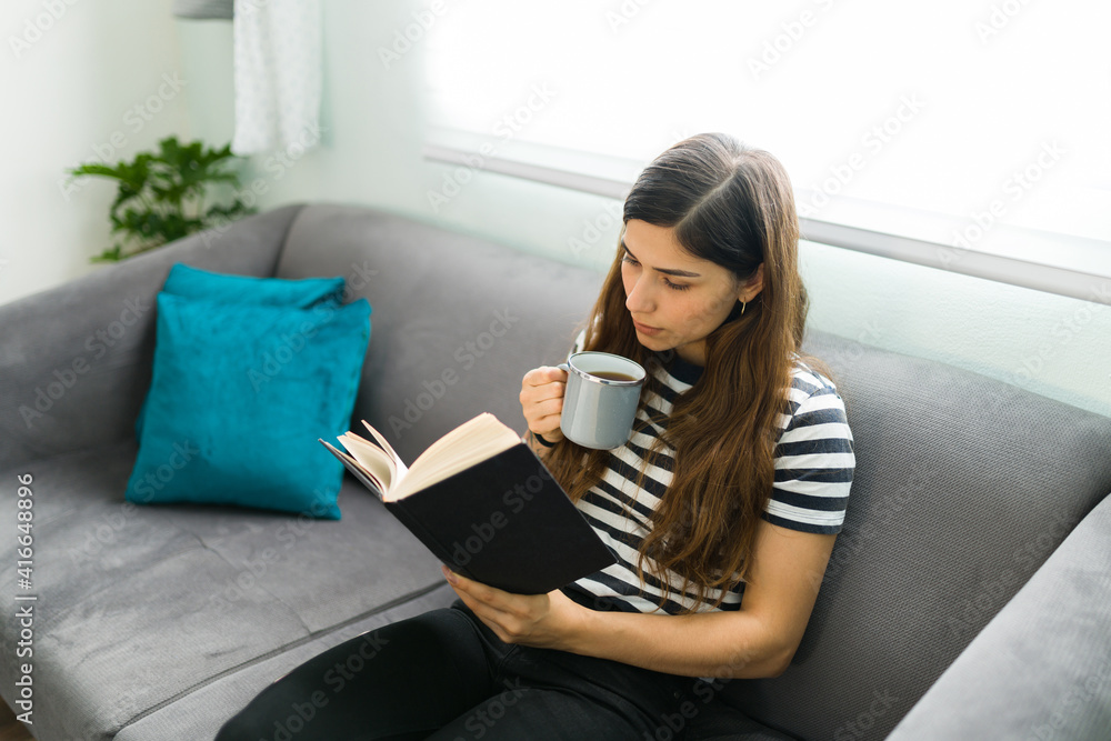 Latin woman reading a novel during a relaxed day Latin woman reading a novel during a relaxed day