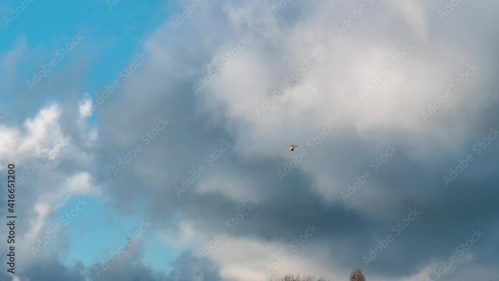 4k shot of a cloudy sky with a helicopter flying away in the distance. 4k shot of a cloudy sky with a helicopter flying away in the distance.