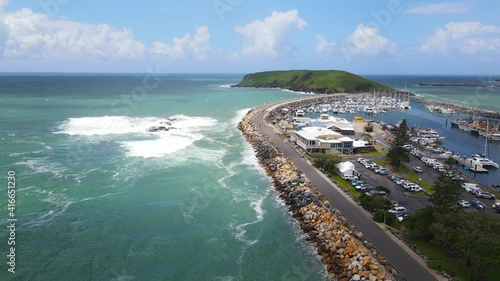 Ocean Waves Crashing Against Seawall Of Marine Drive At Solitary Islands Marine Park - Jetty Near Muttonbird Island Nature Reserve In Coffs Harbour, NSW, Australia. - aerial photo