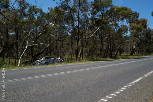 Smashed car left at the side of a country road