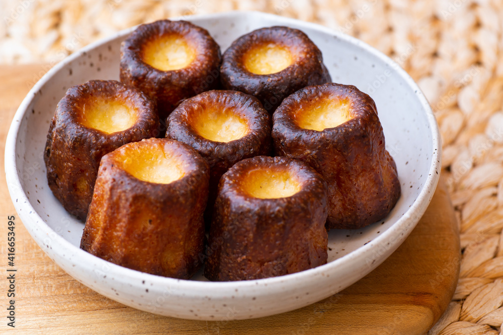 A plate of french pastries, Canelés de BordeauxA plate of french pastries, Canelés de Bordeaux A plate of french pastries, Canelés de BordeauxA plate of french pastries, Canelés de Bordeaux