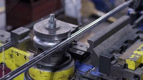 Industrial bender equipment machine for metal pipe bending in the factory. Automatic metalworking machine for electronic turning metal pipe and cold bending at industrial hall at manufacturing plant