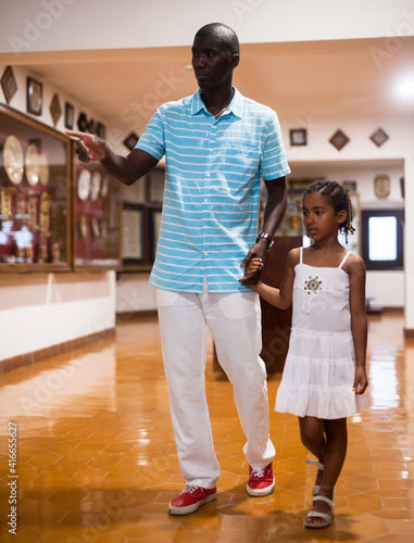 Portrait of African American father and daughter visiting museum of arts