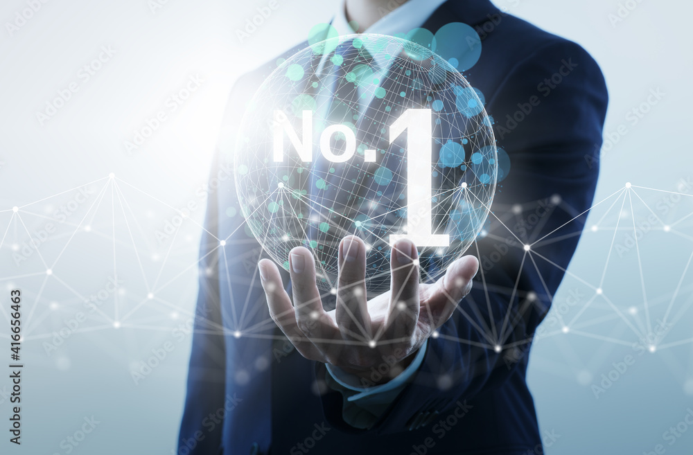 © tadamichi - Achieving first ranking on internet. Businessperson holding word of number one.