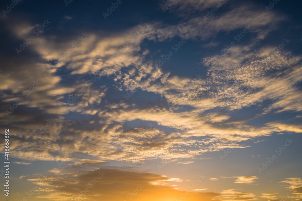 This image showcases a warm sunset sky with glowing clouds.
