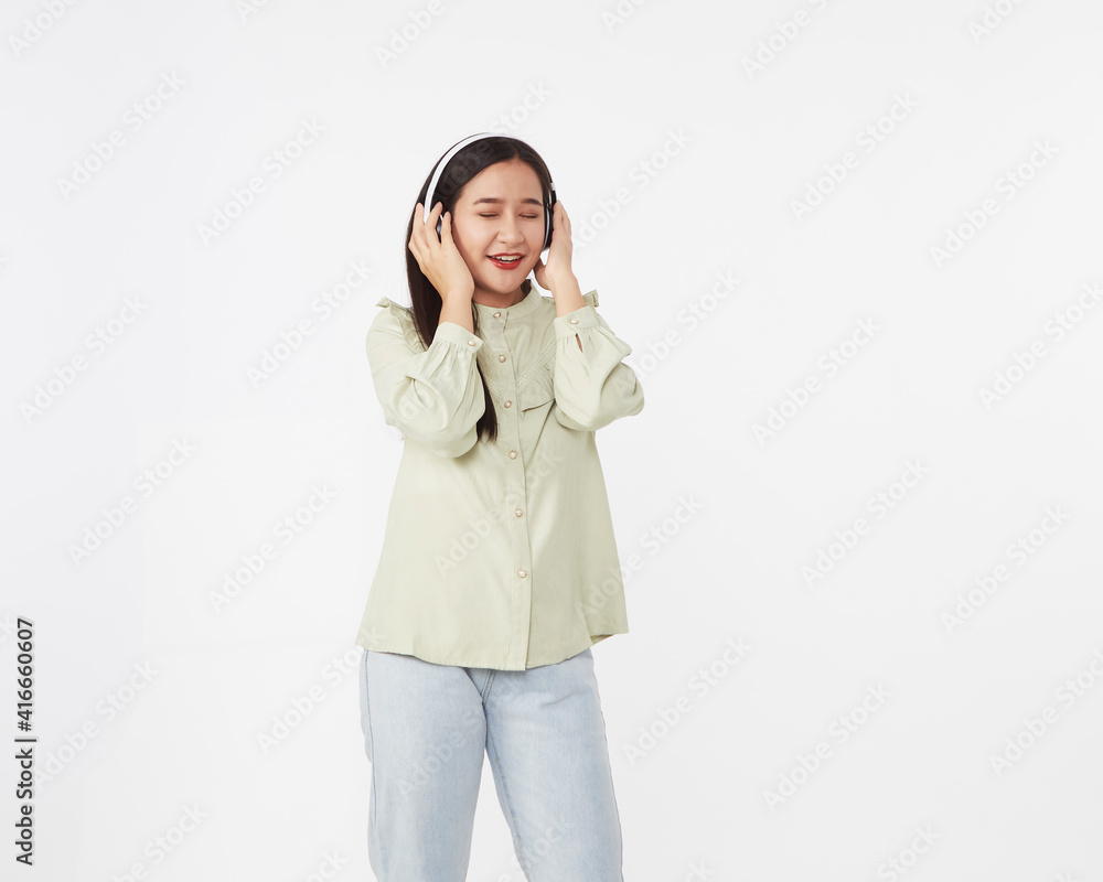 Joyful beautiful young Asian girl in headphones Joyful beautiful young Asian girl in headphones