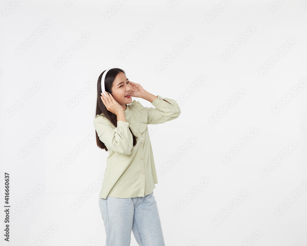 Joyful beautiful young Asian girl in headphones Joyful beautiful young Asian girl in headphones