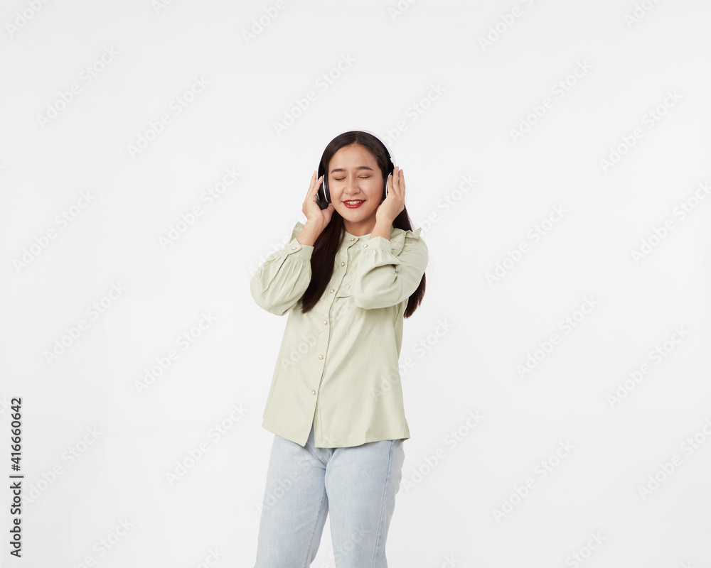 Joyful beautiful young Asian girl in headphones Joyful beautiful young Asian girl in headphones