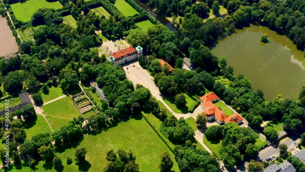 Beautiful avenue of trees of Nieborow Palace, a Baroque style residence in Poland. Colourful foliage in a French-design garden. Aerial view Beautiful avenue of trees of Nieborow Palace, a Baroque style residence in Poland. Colourful foliage in a French-design garden. Aerial view