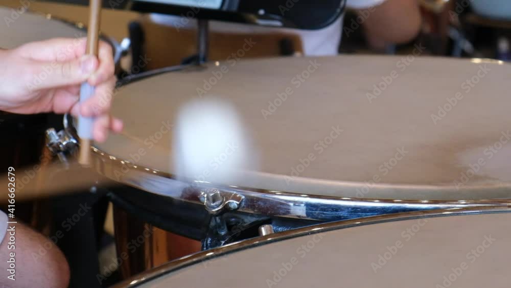 Hands musician playing in slow motion the timpani in the orchestra closeup. Drum sticks hitting the timpani closeup. Hands musician playing in slow motion the timpani in the orchestra closeup. Drum sticks hitting the timpani closeup.