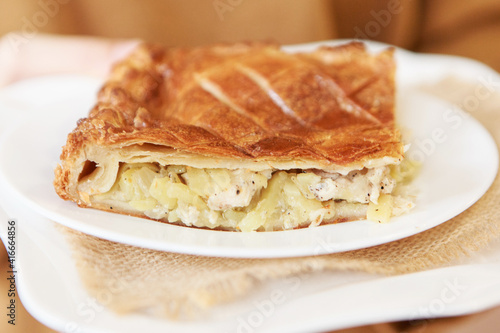Chicken and potato pie on the dining table. The food is ready to eat. Puff pastry. kitchen utensils for cooking