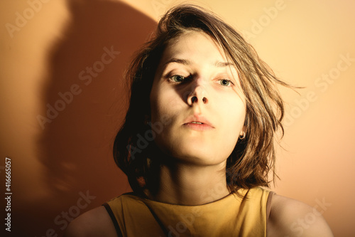 Portrait of a young woman with overexposure. Head thrown back