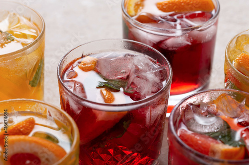 Close up of sangria in glasses with ice and fresh fruits, close up