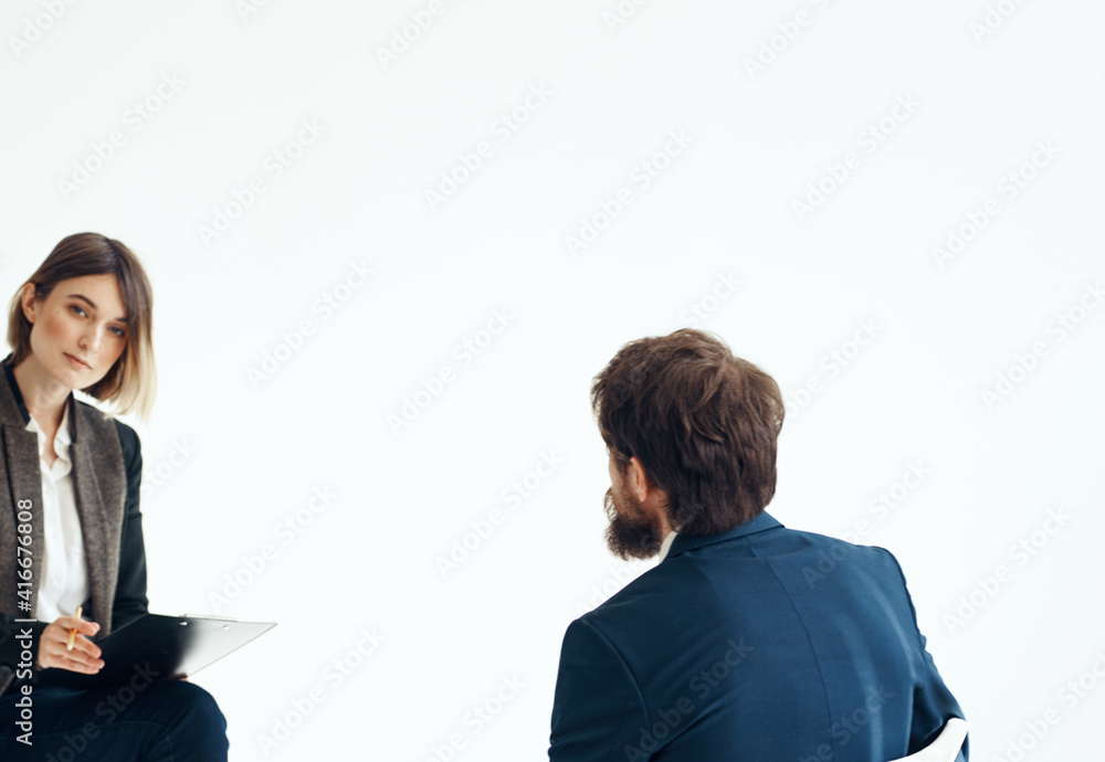 Business man and woman in suit on a light background communication staff job interview Business man and woman in suit on a light background communication staff job interview