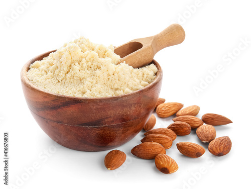 Bowl and scoop with almond flour on white background
