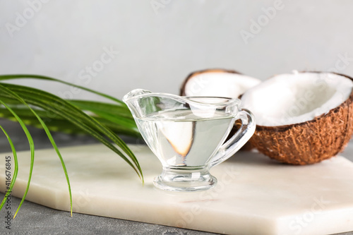 Gravy boat of coconut oil on table