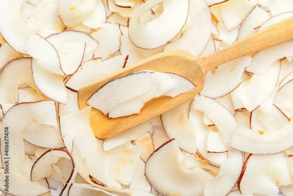 Scoop with tasty coconut chips, closeup Scoop with tasty coconut chips, closeup