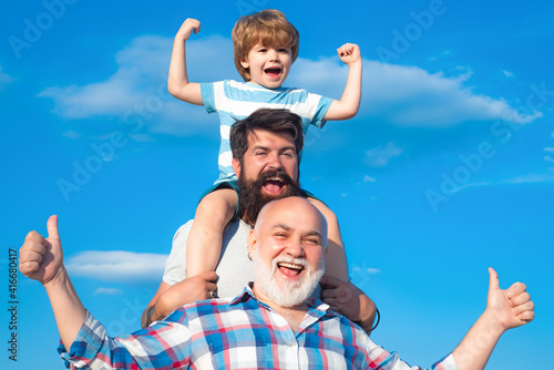 Man family outdoor. Happy three generations of men have fun and smiling on blue sky background. Grandfather father and grandson, son.