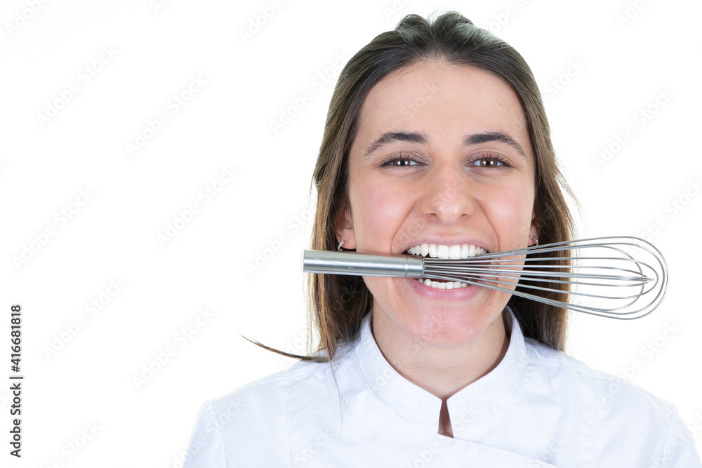 woman chef restaurant showing whisk pastry whip in the mouth between female teeth on white background woman chef restaurant showing whisk pastry whip in the mouth between female teeth on white background