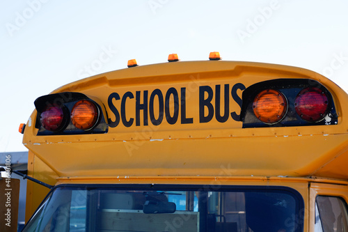 yellow school bus Front view with text sign and security light