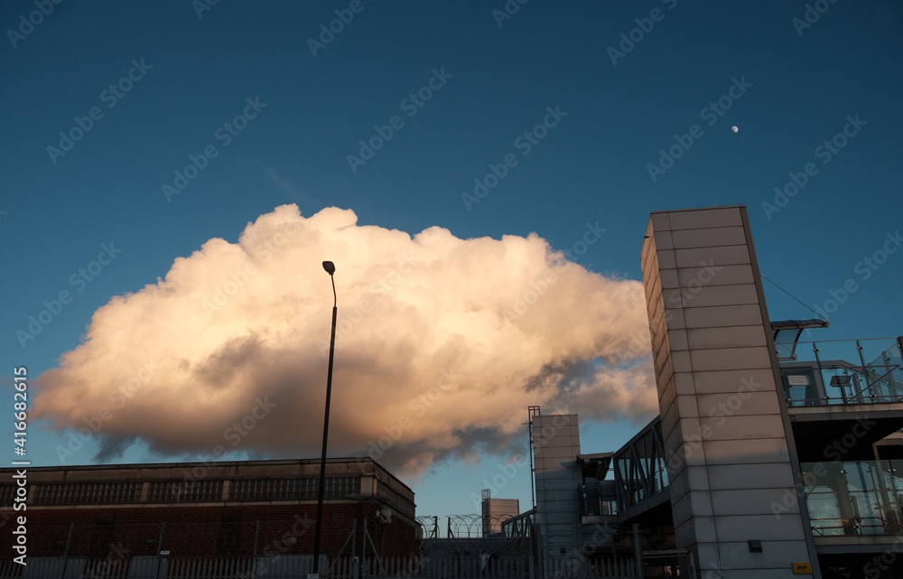 Huge cloud over train station in East London.