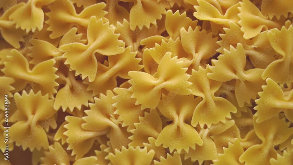 italian pasta farfalle, rotate in a circle, top view italian pasta farfalle, rotate in a circle, top view