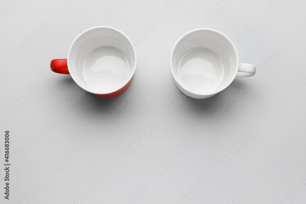 Empty cups on light background Empty cups on light background