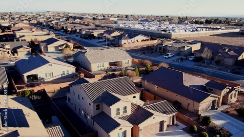 Aerial pan of residential suburban homes and sub division in south west desert community new mexico affluent homes with well manicured yards. photo