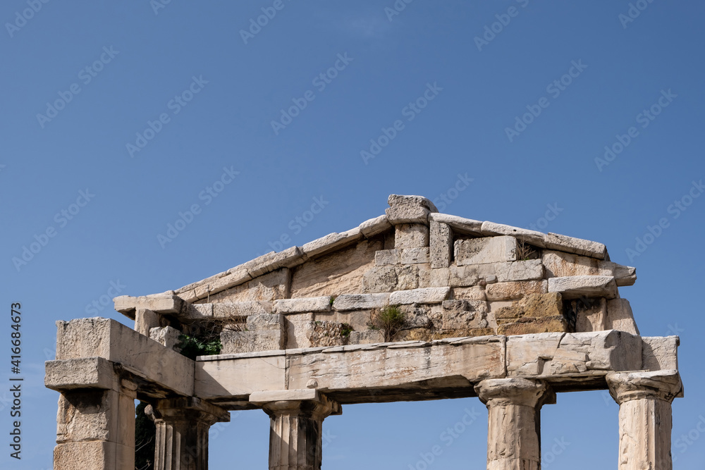 Athens Greece. Gate of Athena Archegetis at Roman Agora background.