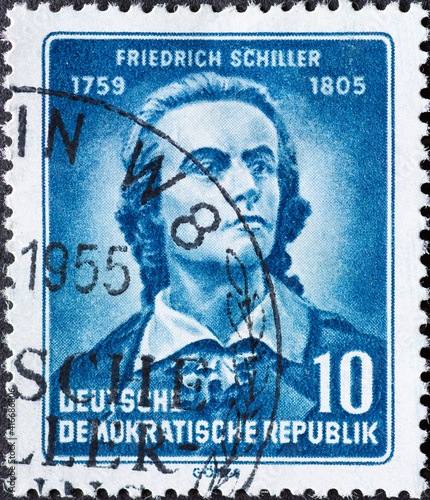 GERMANY, DDR - CIRCA 1955 : a postage stamp from Germany, GDR showing a portrait of the young writer and poet Friedrich Schiller. 150th anniversary of death