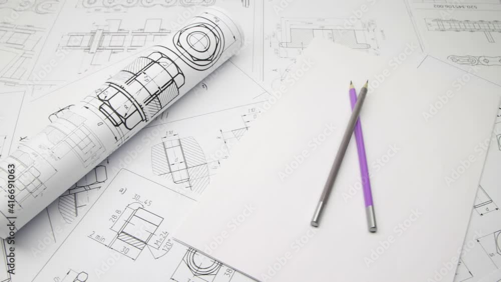 Paper engineering drawings of hardware and pencils. Design engineer project. Paper engineering drawings of hardware and pencils. Design engineer project.