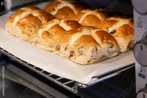 Hot cross buns cooked in an electric oven. Easter food concept