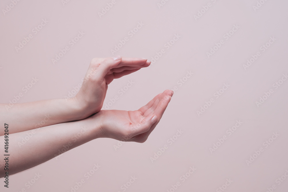 Female hands holding or protecting something gesture. Closeup, copy space. Hand signs communication concept