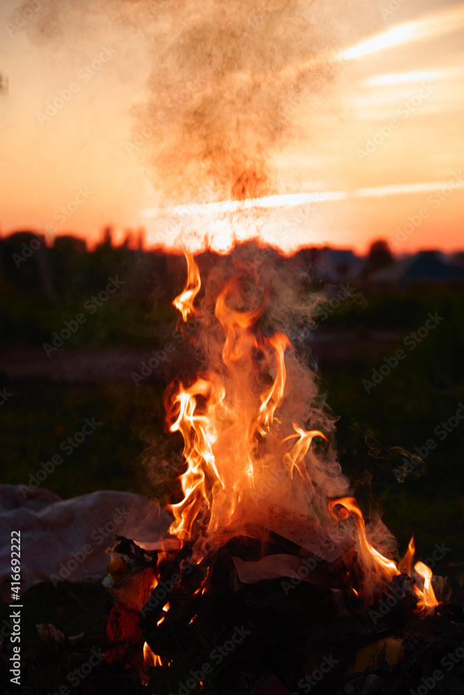 Fire on the background of the sunset. Fire on dark background. Colorful background. Watercolor gradient. 