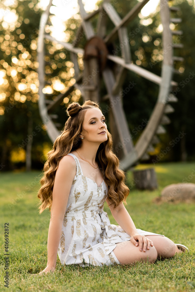 Naklejka premium Beautiful girl with hair and makeup on the street on a sunny day