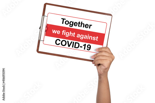 Hand holding white clipboard and paper isolated on white background with campaign "Together we fight against COVID-19" to stop COVID-19. Coronavirus concept.