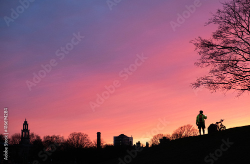 taking photo with his phone on the sunset view