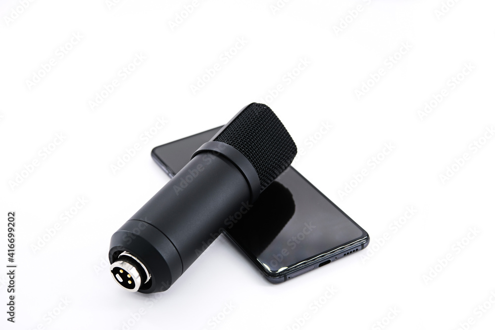 Concept for Clubhouse Drop-in audio is a voice-activated social media app. smartphone and microphone on a white background. Concept for Clubhouse Drop-in audio is a voice-activated social media app. smartphone and microphone on a white background.