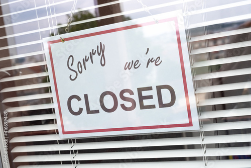 Wallpaper Mural Closed sign hanging behind a store window Torontodigital.ca