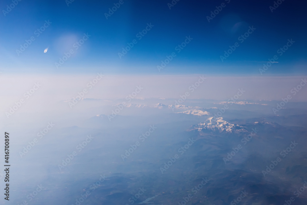Mountain view from an airplane window. Travel holiday background