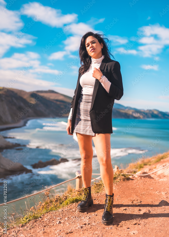 A young brunette enjoying a summer afternoon on the coast of the basque country, zumaia. Gipuzkoa A young brunette enjoying a summer afternoon on the coast of the basque country, zumaia. Gipuzkoa
