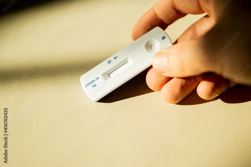 holding a covid-19 test in hand holding a covid-19 test in hand