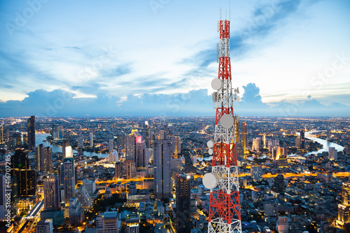 Telecommunication tower with 5G cellular network antenna on night city background