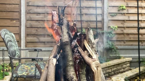 Burning woods in barbecue brazier in the garden.