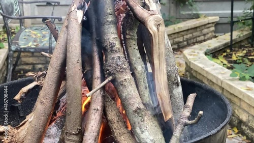 Burning woods in barbecue brazier in the garden.